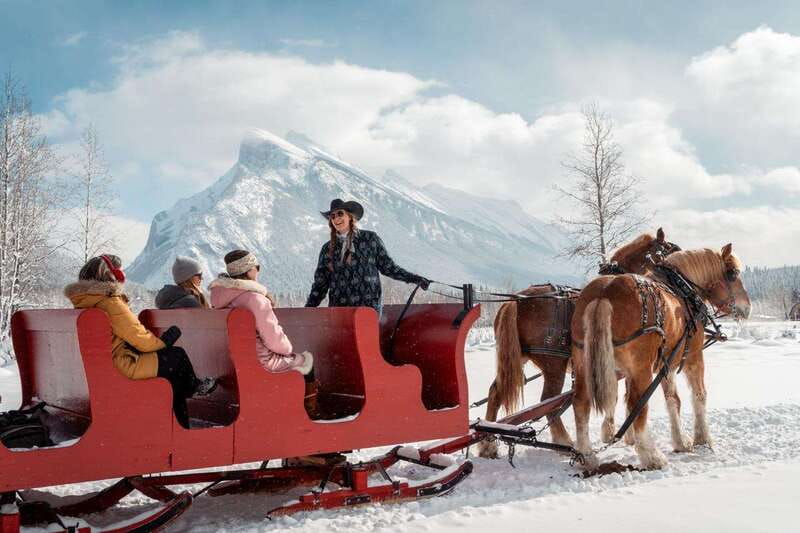 Banff: Family Friendly Horse-Drawn Sleigh Ride - Climbing aboard beneath wool blankets
