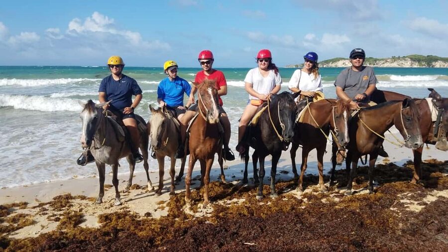 Punta Cana: Horseback Ride to Macao Beach - Riding through a traditional village