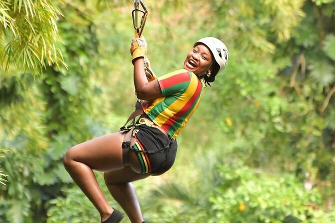 Zipline, Dunn’s River Falls, Bamboo Rafting & Horseback Ride Tour - Ziplining above the waterfalls